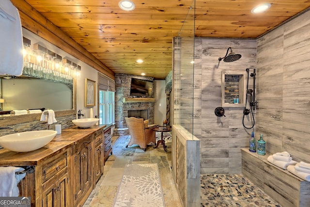 bathroom featuring a shower, wood ceiling, wooden walls, and dual bowl vanity