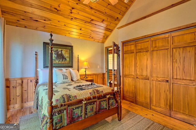 bedroom with light hardwood / wood-style flooring, a closet, wooden ceiling, and lofted ceiling