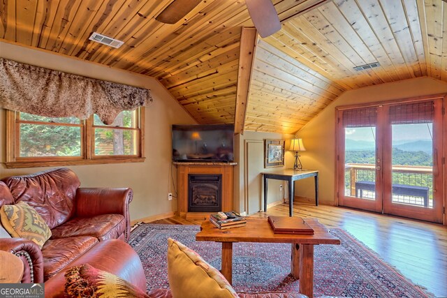 living room with plenty of natural light, wooden ceiling, lofted ceiling, and light hardwood / wood-style floors