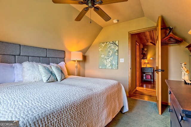 carpeted bedroom featuring lofted ceiling and ceiling fan