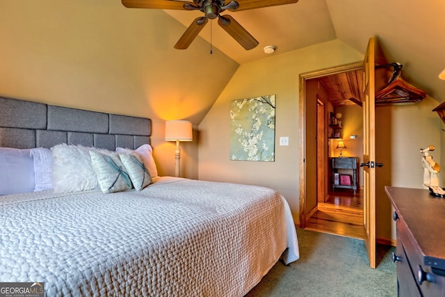 carpeted bedroom with lofted ceiling