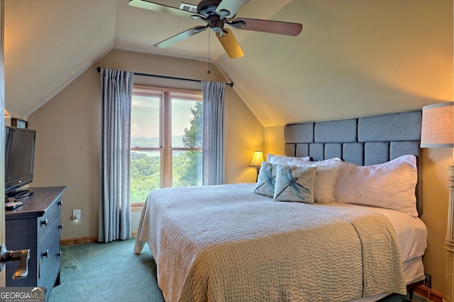 carpeted bedroom featuring vaulted ceiling, multiple windows, and ceiling fan