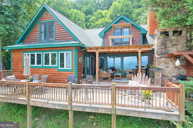 back of property featuring a wooden deck and an outdoor living space