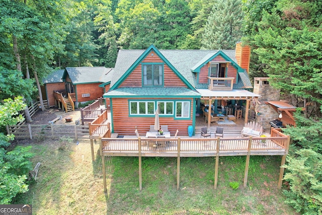 rear view of house featuring a deck