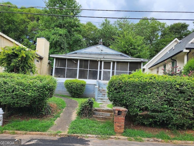 bungalow-style house with a sunroom