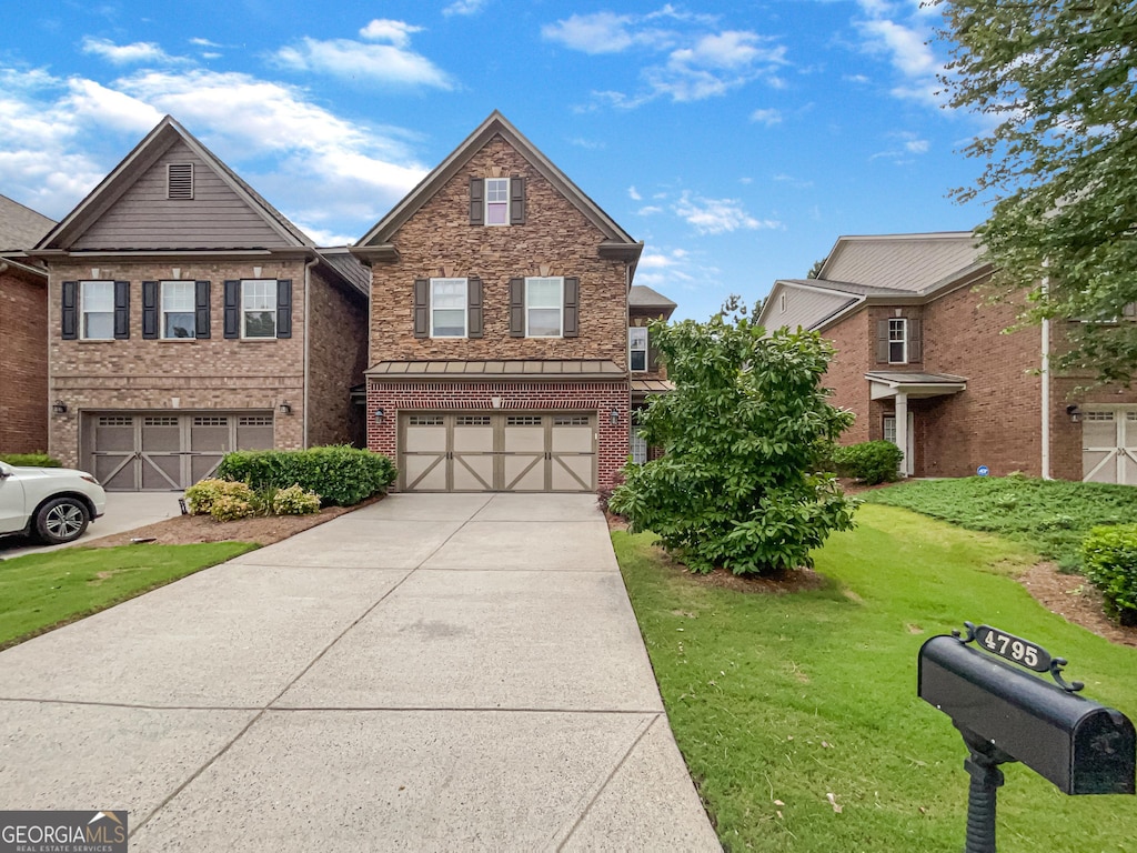 view of front of home with a garage and a front lawn