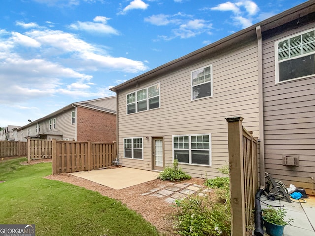 rear view of property with a patio area and a yard