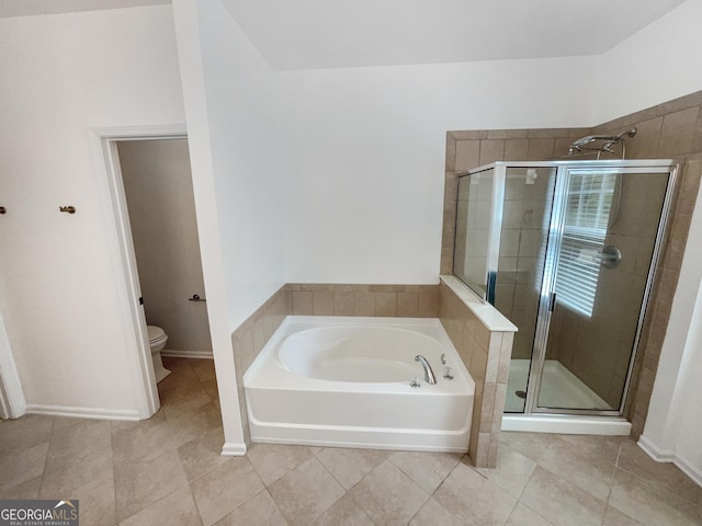 bathroom featuring toilet, tile patterned floors, and plus walk in shower