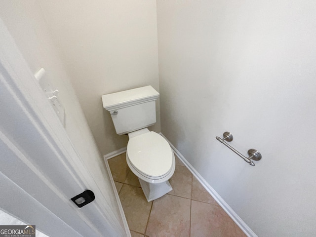 bathroom with toilet and tile patterned floors