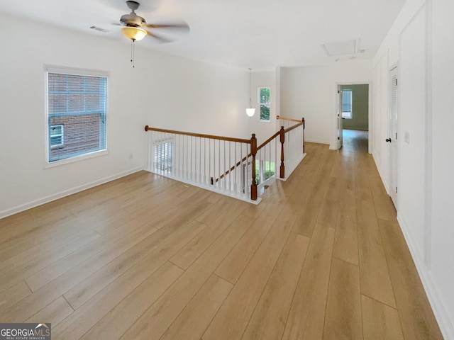 spare room featuring ceiling fan and light hardwood / wood-style flooring