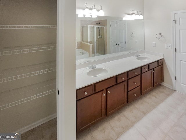 bathroom with walk in shower, tile patterned floors, and vanity