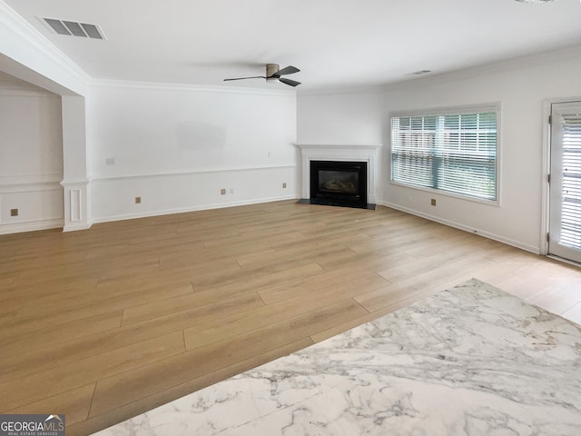 unfurnished living room with ceiling fan, light hardwood / wood-style flooring, and crown molding