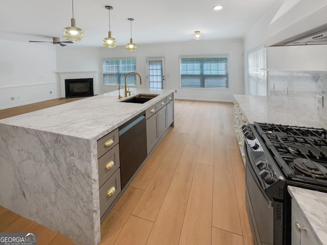 kitchen featuring a spacious island, black appliances, custom exhaust hood, decorative light fixtures, and sink