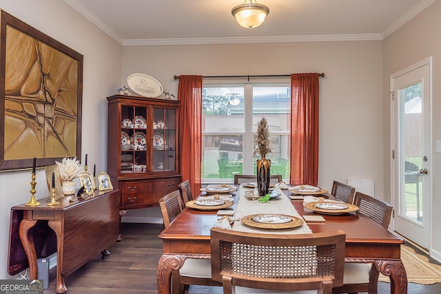 dining area with crown molding and dark wood-type flooring