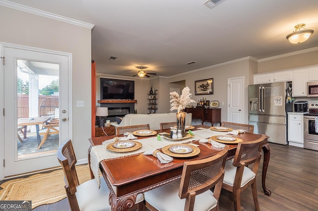 dining space with ornamental molding, dark hardwood / wood-style floors, and ceiling fan