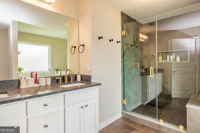 bathroom featuring an enclosed shower and vanity