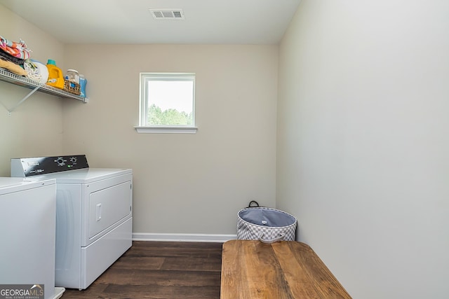 washroom with dark wood-type flooring and washer and clothes dryer