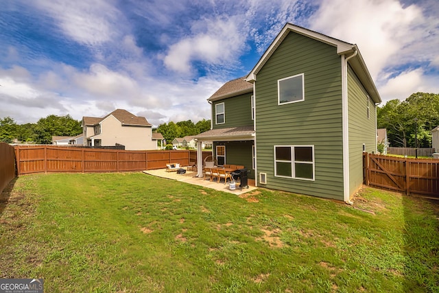 rear view of property featuring a yard and a patio area