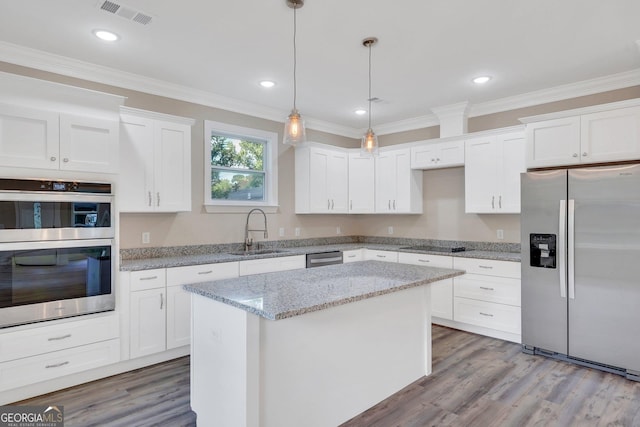 kitchen featuring sink, a center island, white cabinetry, and stainless steel appliances