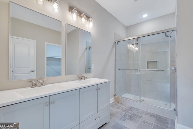 bathroom with a shower with door and vanity