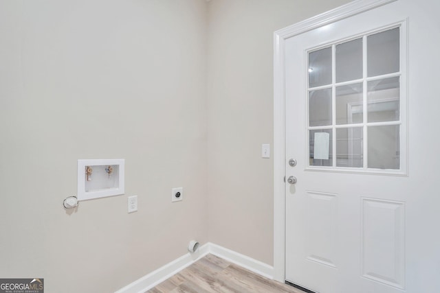 clothes washing area with hookup for an electric dryer, light hardwood / wood-style floors, and washer hookup