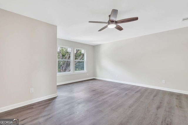 spare room with light wood-type flooring and ceiling fan