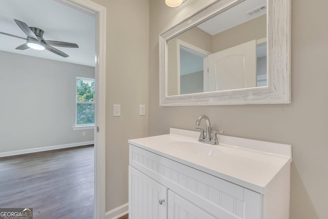 bathroom featuring ceiling fan, hardwood / wood-style floors, and vanity