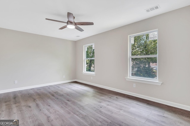 unfurnished room with a wealth of natural light and light hardwood / wood-style flooring