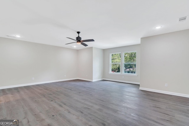 spare room featuring wood-type flooring and ceiling fan