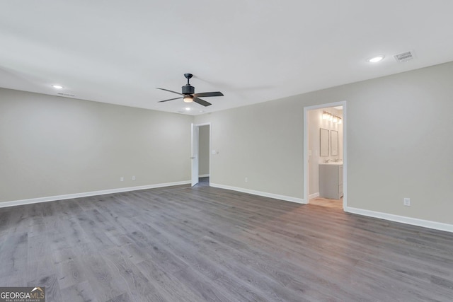 unfurnished room featuring ceiling fan and hardwood / wood-style floors