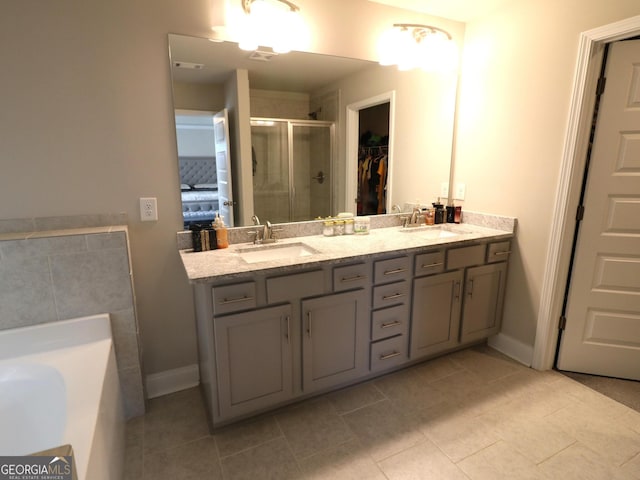 bathroom featuring tile patterned flooring, double vanity, and plus walk in shower