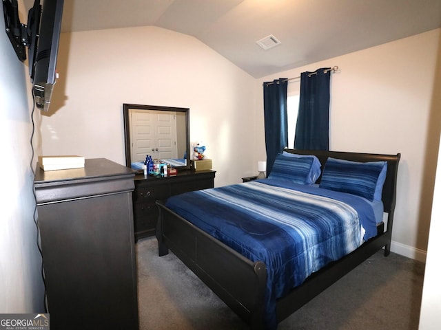 bedroom with carpet flooring and vaulted ceiling