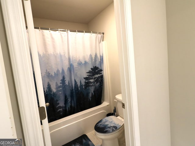 bathroom with shower / bath combo, toilet, and tile patterned floors