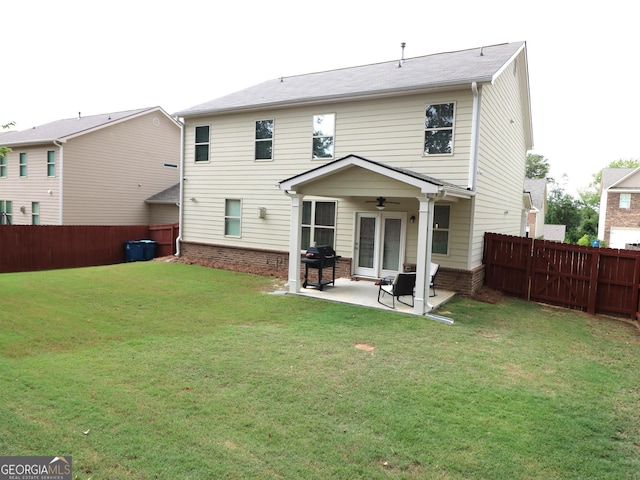 rear view of house featuring a patio area, ceiling fan, and a yard