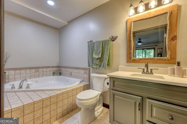 bathroom with vanity, tile patterned flooring, ceiling fan, toilet, and tiled bath