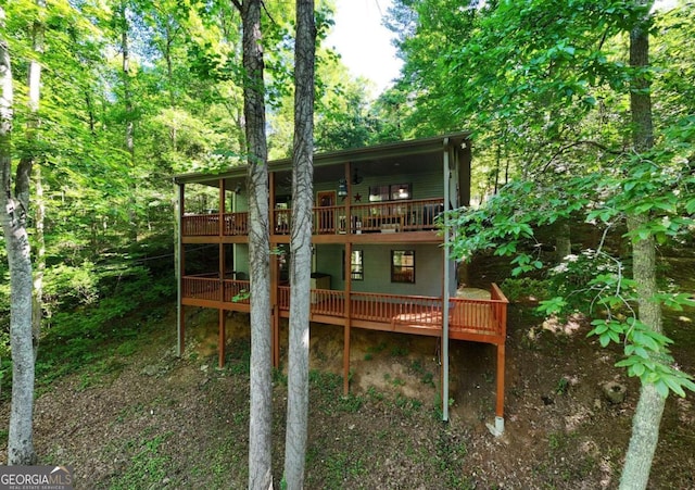 rear view of house featuring a deck