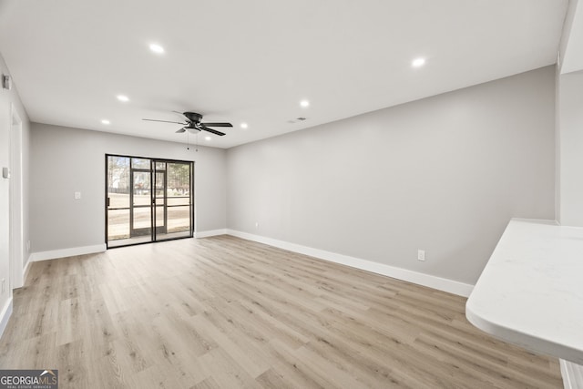 unfurnished room with ceiling fan and light wood-type flooring