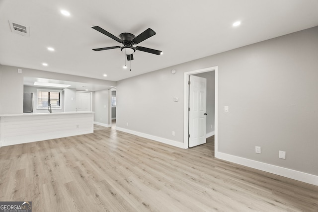 unfurnished living room featuring light wood-type flooring and ceiling fan