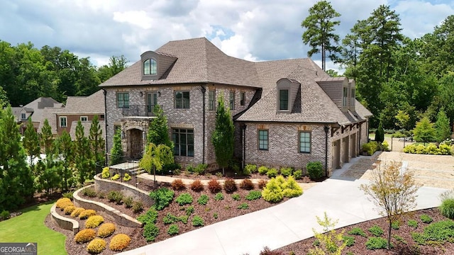 french country inspired facade featuring a garage