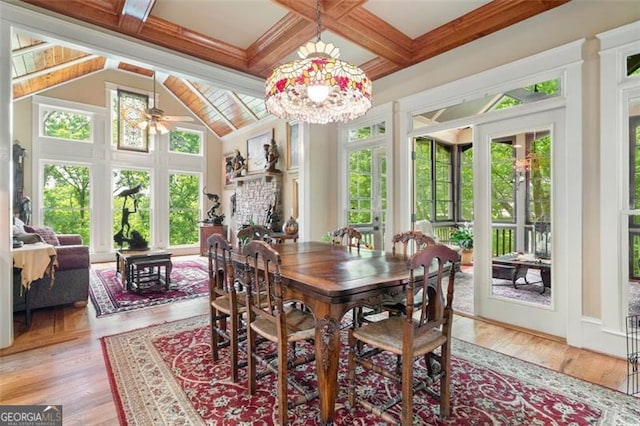 dining room with beam ceiling, light hardwood / wood-style floors, and coffered ceiling