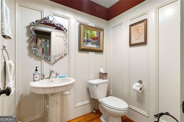 bathroom featuring toilet and wood-type flooring