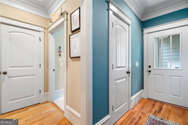 interior space with light hardwood / wood-style flooring and ornamental molding