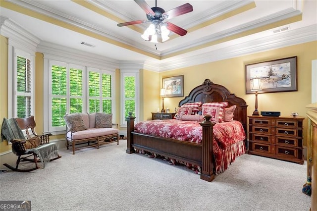 bedroom featuring ornamental molding, carpet floors, ceiling fan, and a raised ceiling