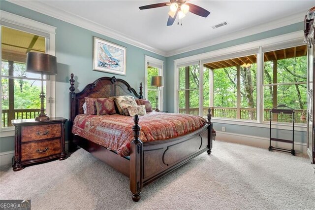 carpeted bedroom featuring ceiling fan and ornamental molding