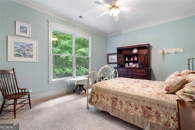 bedroom with carpet floors, ceiling fan, and crown molding