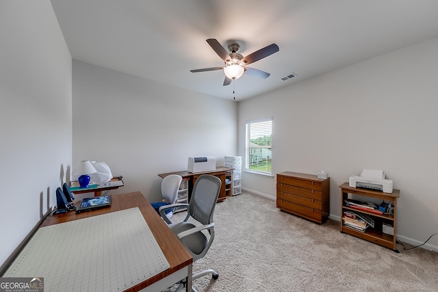 carpeted office space with ceiling fan