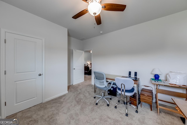 office space featuring light carpet and ceiling fan