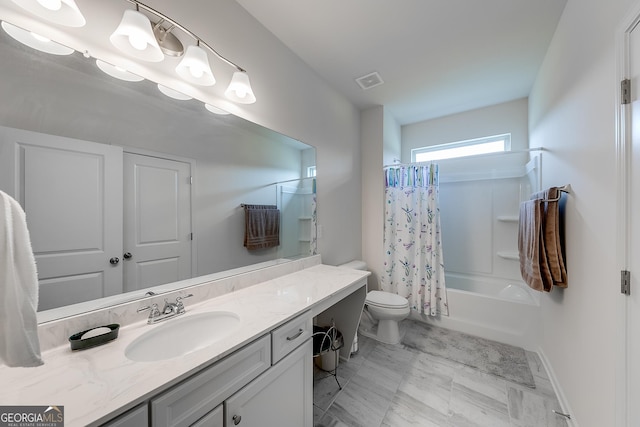 full bathroom featuring shower / bath combo with shower curtain, toilet, and vanity