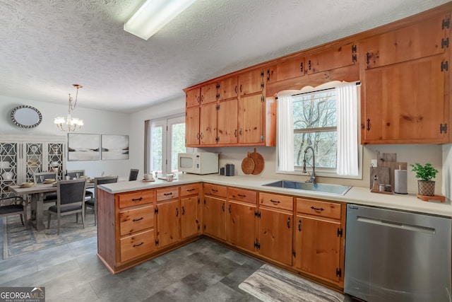 kitchen featuring a sink, a peninsula, light countertops, white microwave, and dishwasher