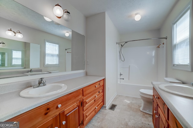 full bathroom with visible vents, baseboards, toilet, shower / bathing tub combination, and vanity